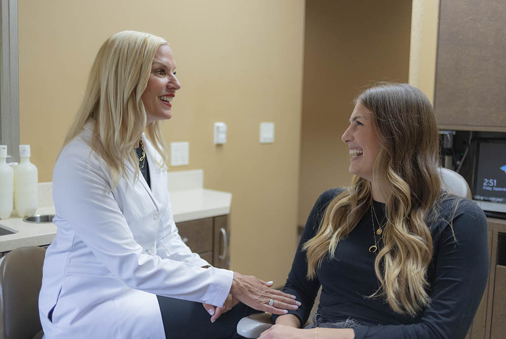 Dr. Jana Gyurina happily talks to a patient of Oak Park Dental